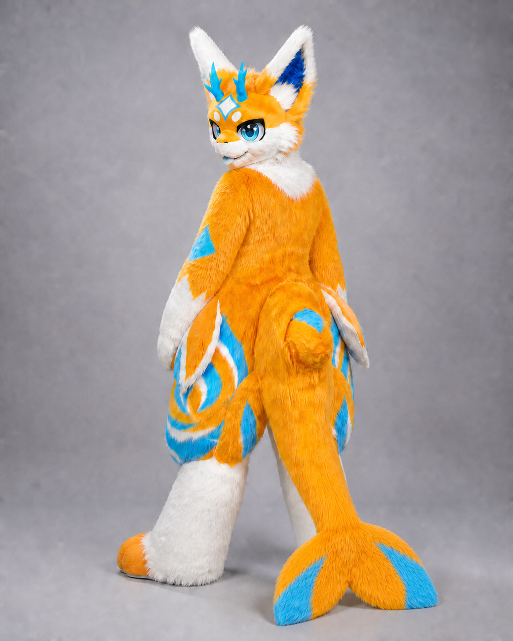 CHIYAN — a one-of-one kemono fullsuit by Fulu Fursuits in orange and white with cyan markings, four blue horns, blue eyes and a broad finned tail
