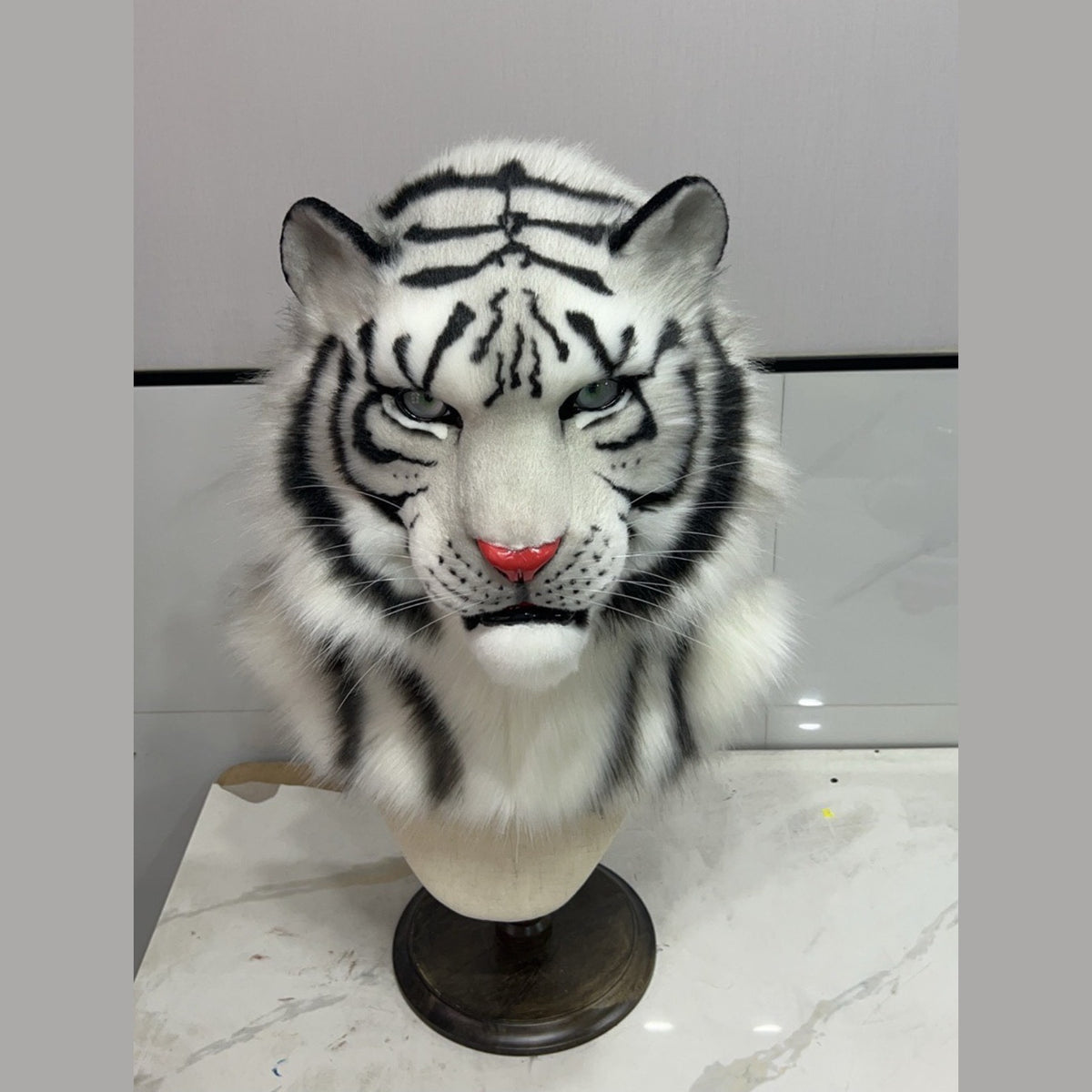 FROST — a one-of-one realistic white tiger fursuit head by Fulu Fursuits, white faux fur with black stripes, pale green eyes and a coral nose