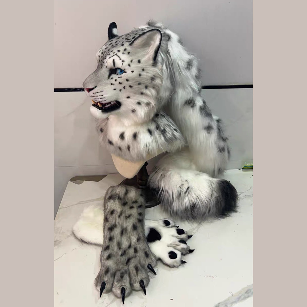 GHOST — a one-of-one realistic snow leopard partial by Fulu Fursuits: head, handpaws and tail in gray and white with black rosettes and blue eyes