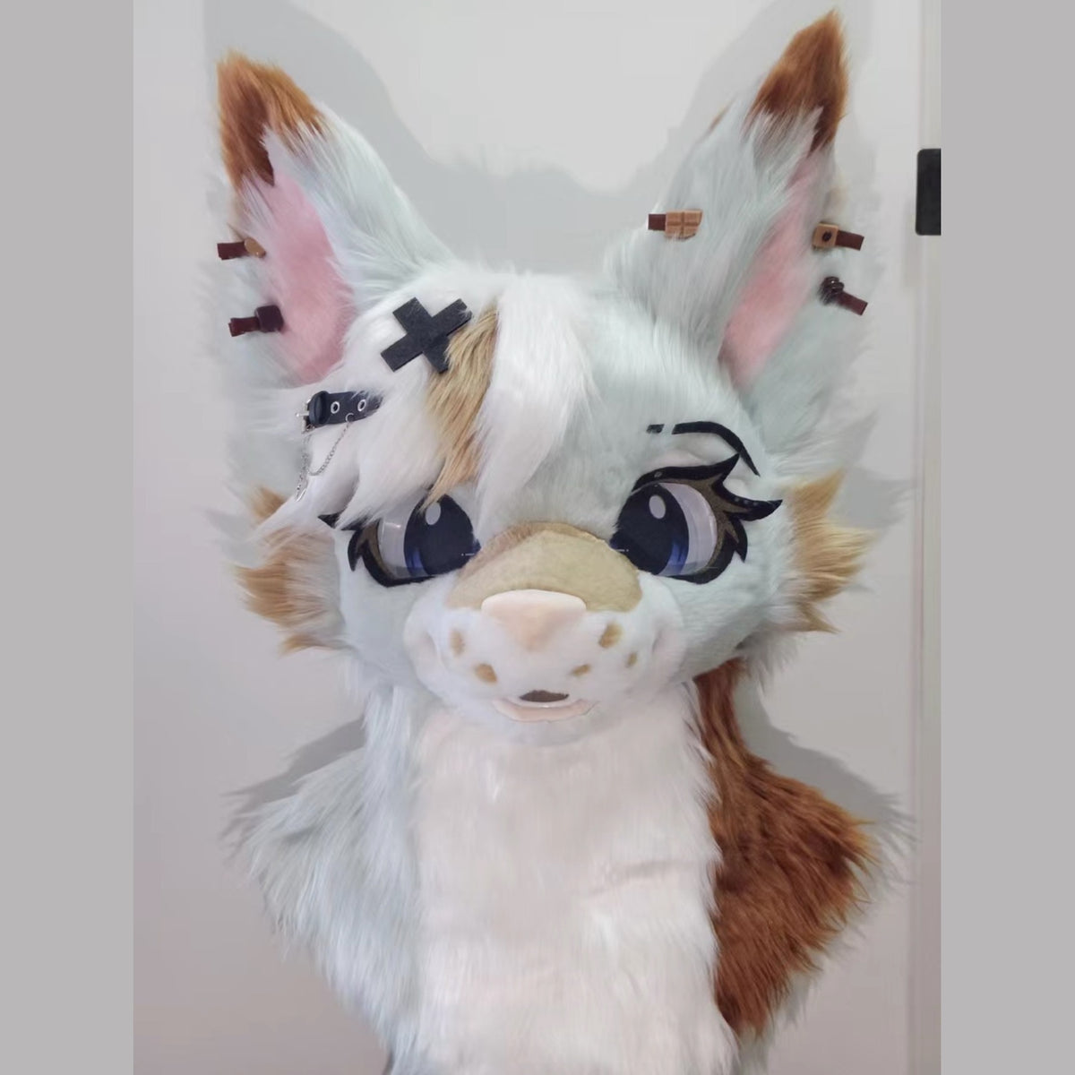 LATTE — a one-of-one toony fursuit head by Fulu Fursuits in mint white and caramel, with tall pink-lined ears and large stylised eyes