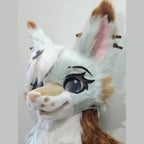 LATTE — a one-of-one toony fursuit head by Fulu Fursuits in mint white and caramel, with tall pink-lined ears and large stylised eyes