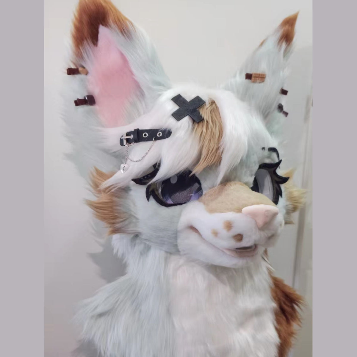 LATTE — a one-of-one toony fursuit head by Fulu Fursuits in mint white and caramel, with tall pink-lined ears and large stylised eyes