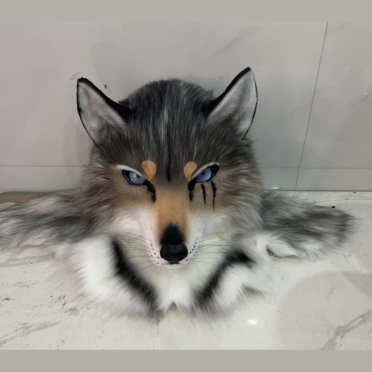 NOTCH — a one-of-one realistic wolf fursuit head by Fulu Fursuits in gray and white with blue eyes and three red marks under one eye