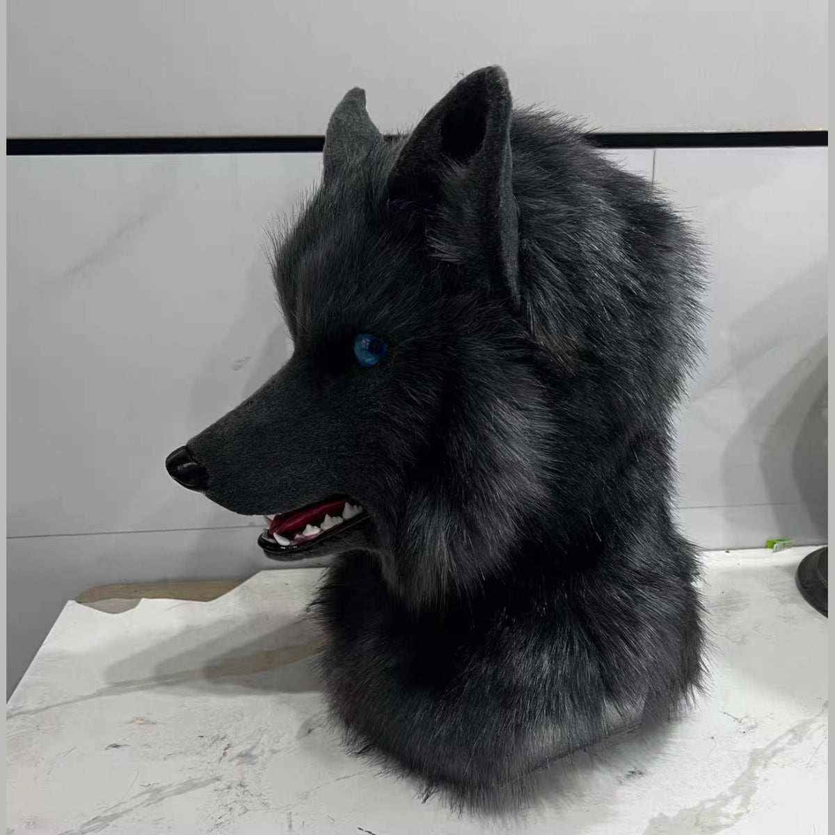 PITCH — a one-of-one realistic wolf partial by Fulu Fursuits: head and handpaws in near-black faux fur with blue eyes